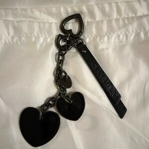 Rare Juicy Couture all black bag charm, comes with a pink choose juicy gift bag